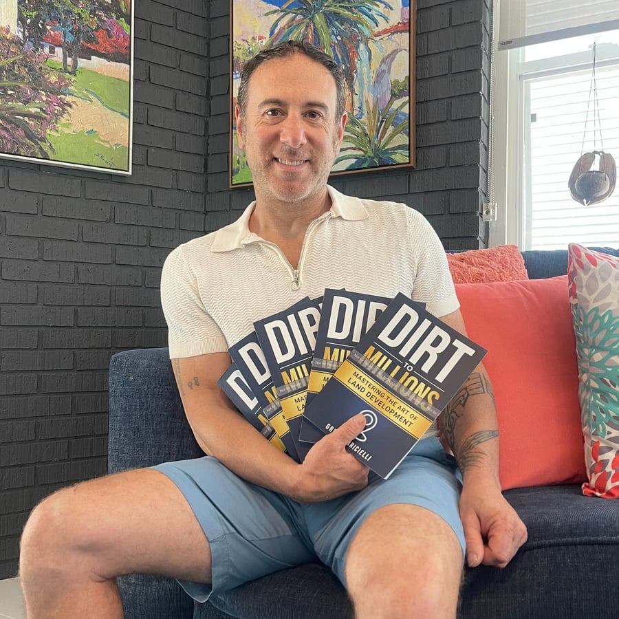 Greg Farricielli, founder of Middle TN Land Buyers, holding his book Dirt to Millions